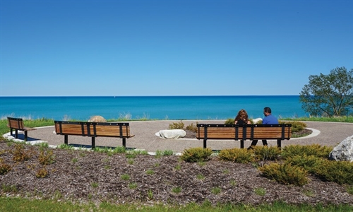 Couple sitting on a bench looking out at Lake Michigan from Fort Sheridan Forest Preserve