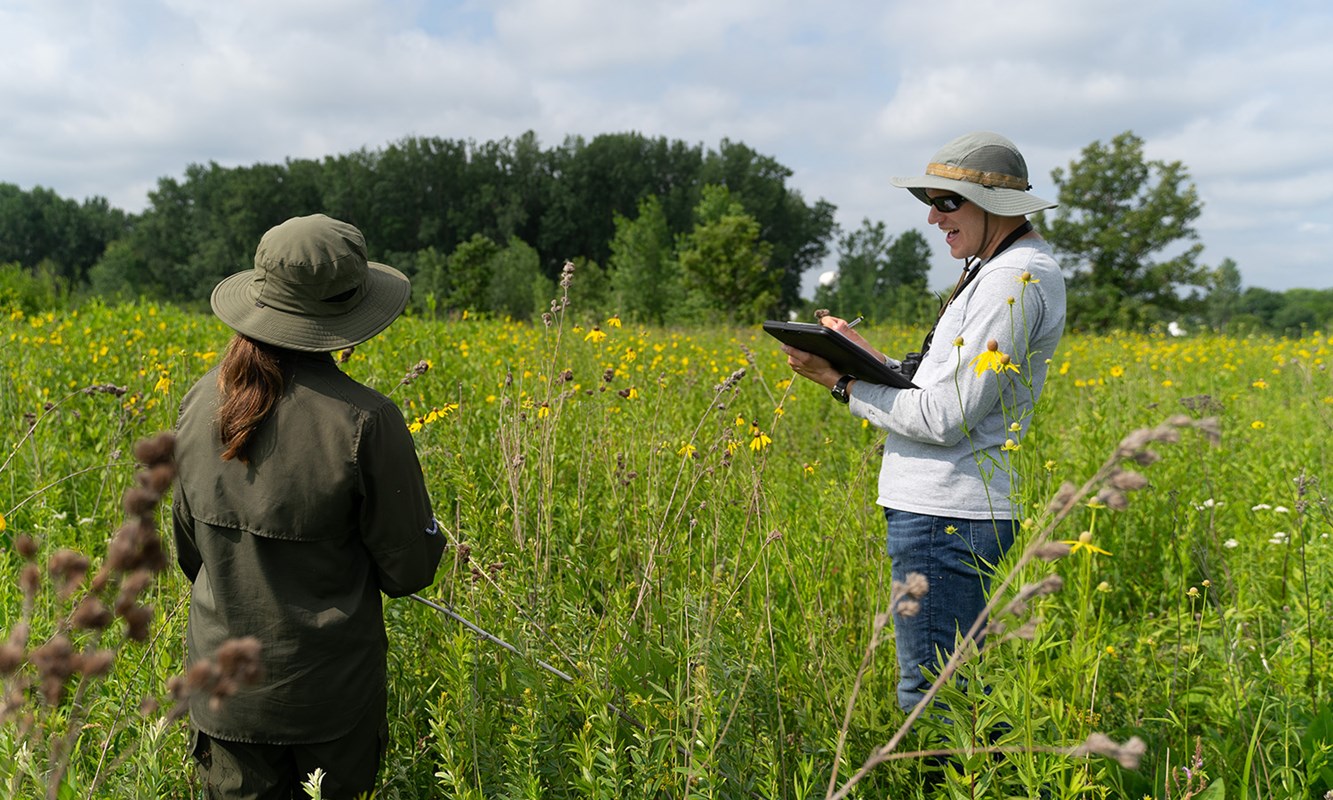 Two Natural Resource Technicians monitoring plants