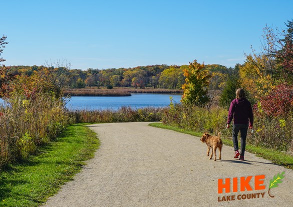 Hiker and dog on a Hike Lake County trail.