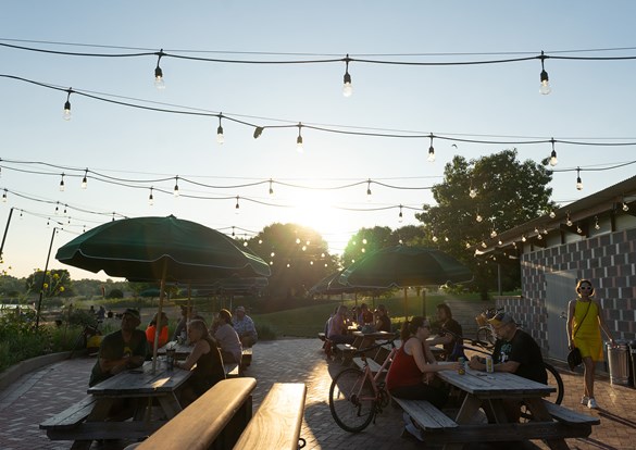 People sitting at picnic tables at the IG Beer Garden