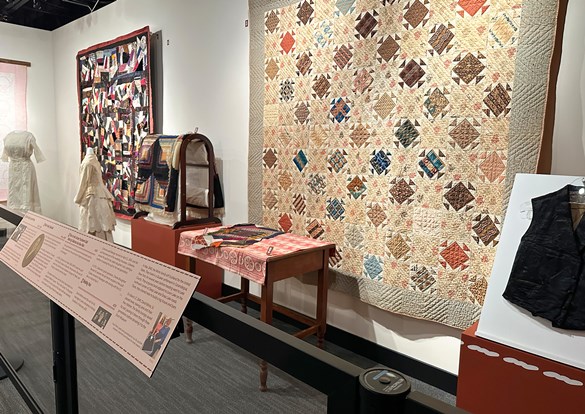 Multicolored hand sewn quilts on display at Dunn Museum.