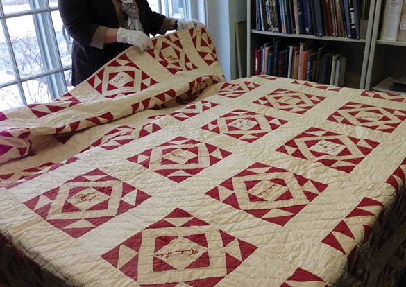 Antique red and white patchwork hand sewn quilt.