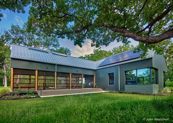 Net-Zero Education Center with solar panels on the roof, highlighting sustainable living and modern architecture.