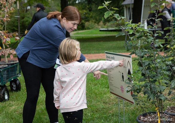 Mother and daughter looking at native trees.
