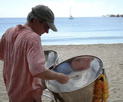 Todd Donnelly playing steel drums on the beach.