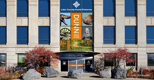 Large building with large windows with a sign reading Dunn Museum.