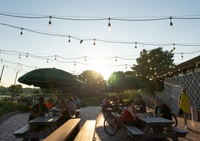 People sitting at picnic tables at the IG Beer Garden
