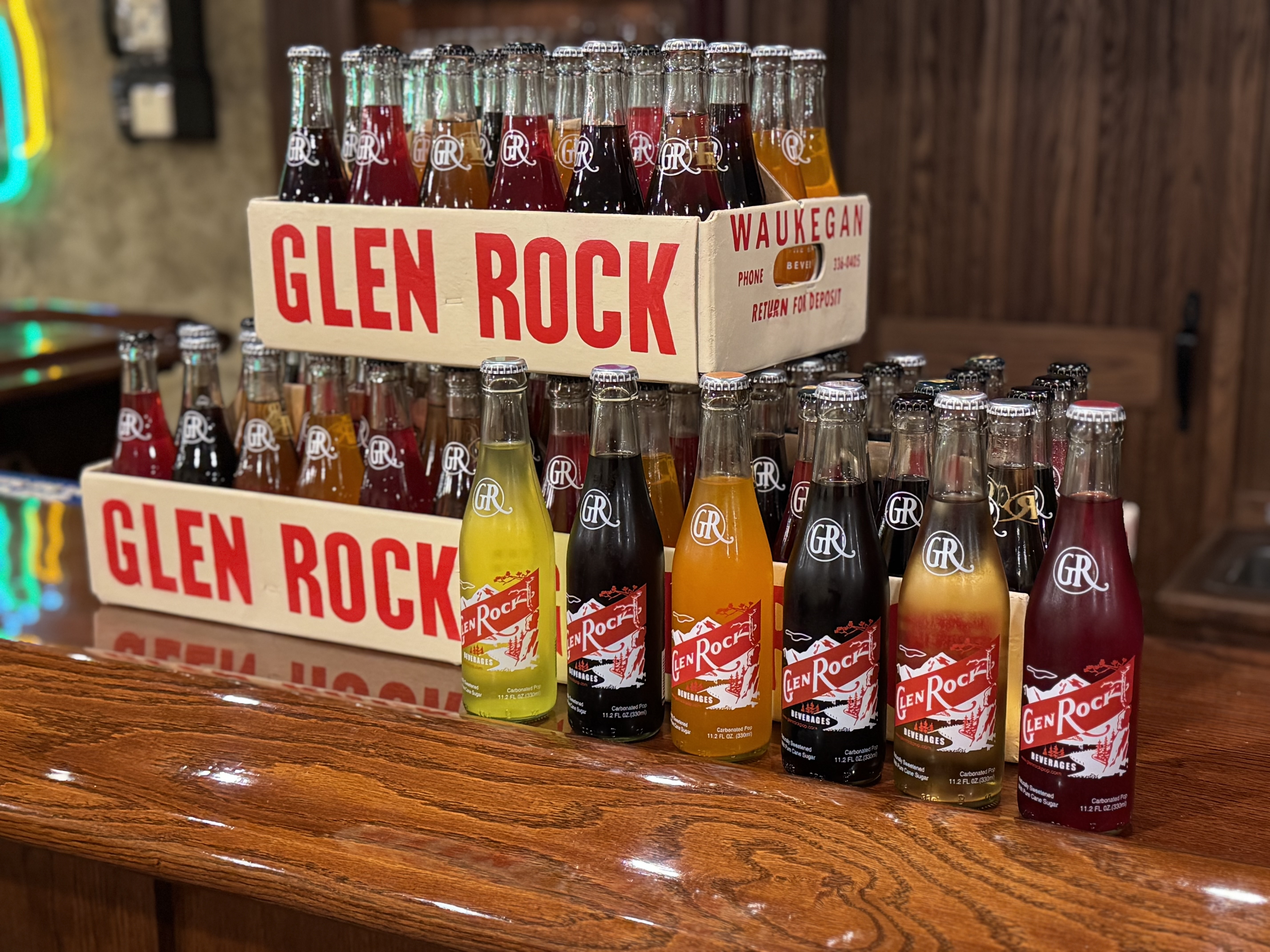 Glen Rock soda bottles, different colors, all lined up together.