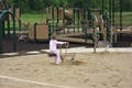 Young girl playing in the sand.