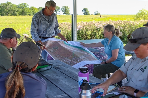 Group of educators in a field during a teacher workshop.