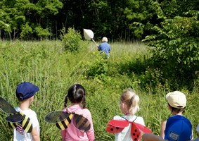 Young Nature Explorers learning how to catch bug with nets.