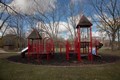 Bright red playground set with slides and castle towers.