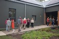 Group of people walking in and out of a building.