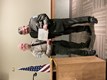 Two police officers shaking hands while receiving an award.