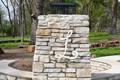 Stone fireplace with a large letter 'L' on it.