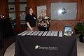 Two woman standing behind a table with nametags.