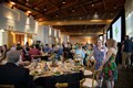 Large group of people mingling in a banquet hall.