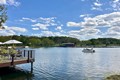 Blue skies over the pedal pontoon boat floating on the water.