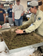 Instructor showing kids how to separate seeds.