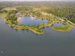 Aerial view of trails and lakes surrounded by trees.