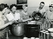 1950's image, woman pealing and slicing peaches to be canned.