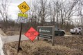 Bright orange Prescribed Burn sign along roadside.