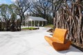 Osage orange fence with bench made from tree stump.