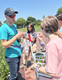 Instructor teaching kids about different species of bees.