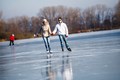 A couple holding hands while ice skating