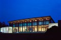 Greenbelt Cultural Center lite up against a deep blue night sky.