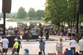 A vibrant crowd captivated by a live band on stage, with fans cheering and enjoying the music together.