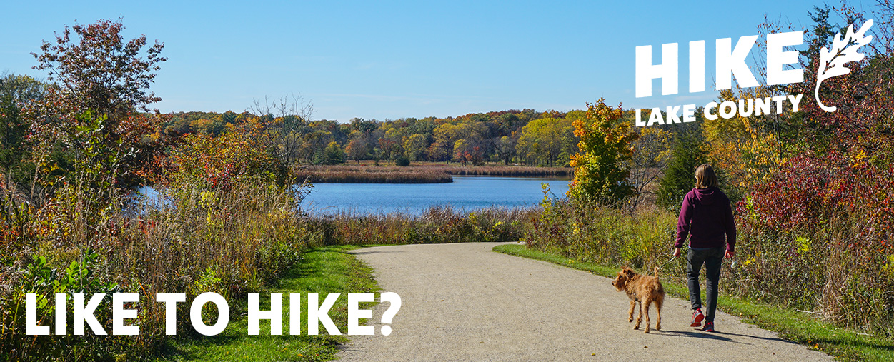 Like to Hike? Hike Lake County. Hiker walking with dog.