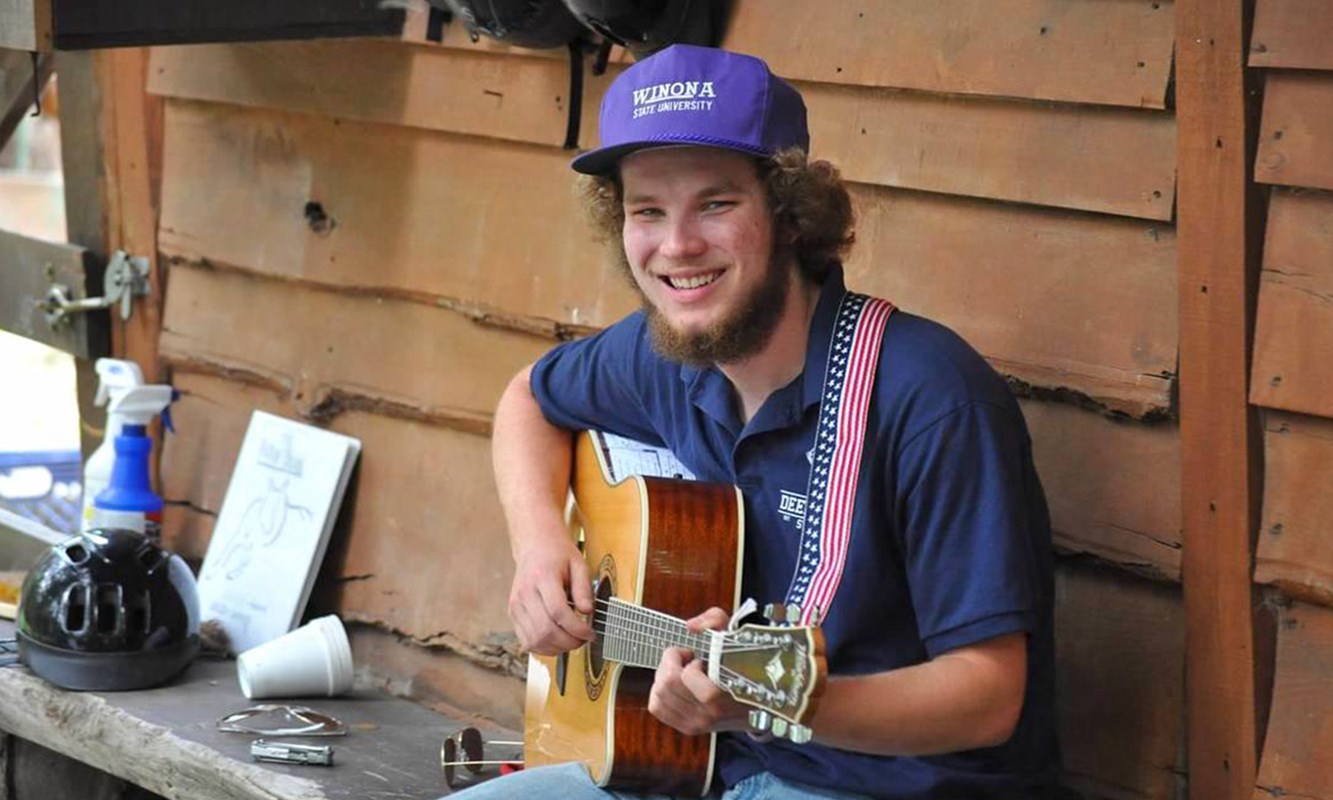 Derek playing guitar outdoors