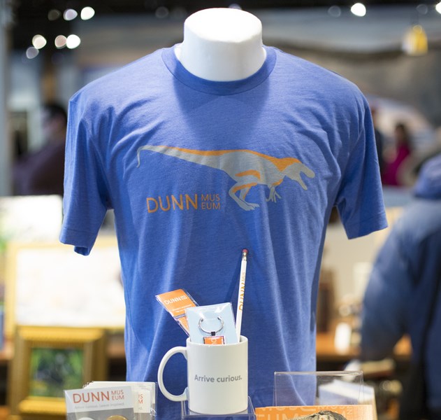 Photo of the blue Dunn Museum tshirt wtih dinosaur on it
