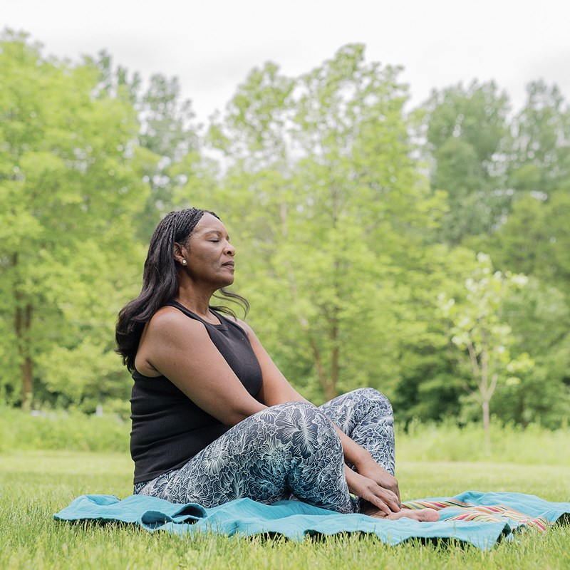 Instructor relaxing in the woods while teaching forest bathing.